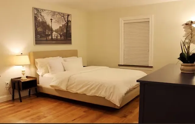 a bedroom with a bed and a desk