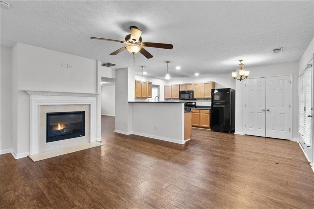 307 Meadows Lane Canton, GA 30114 - Photo 13 of 33 a view of a kitchen with a sink a kitchen microwave and a refrigerator