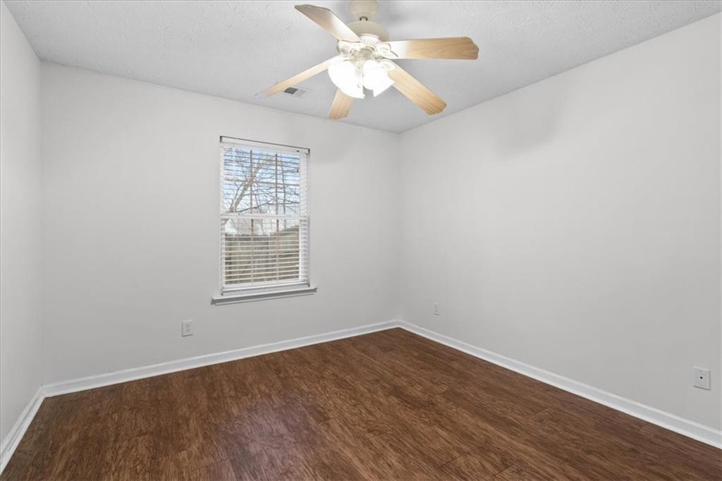 307 Meadows Lane Canton, GA 30114 - Photo 14 of 33 wooden floor in an empty room with a window