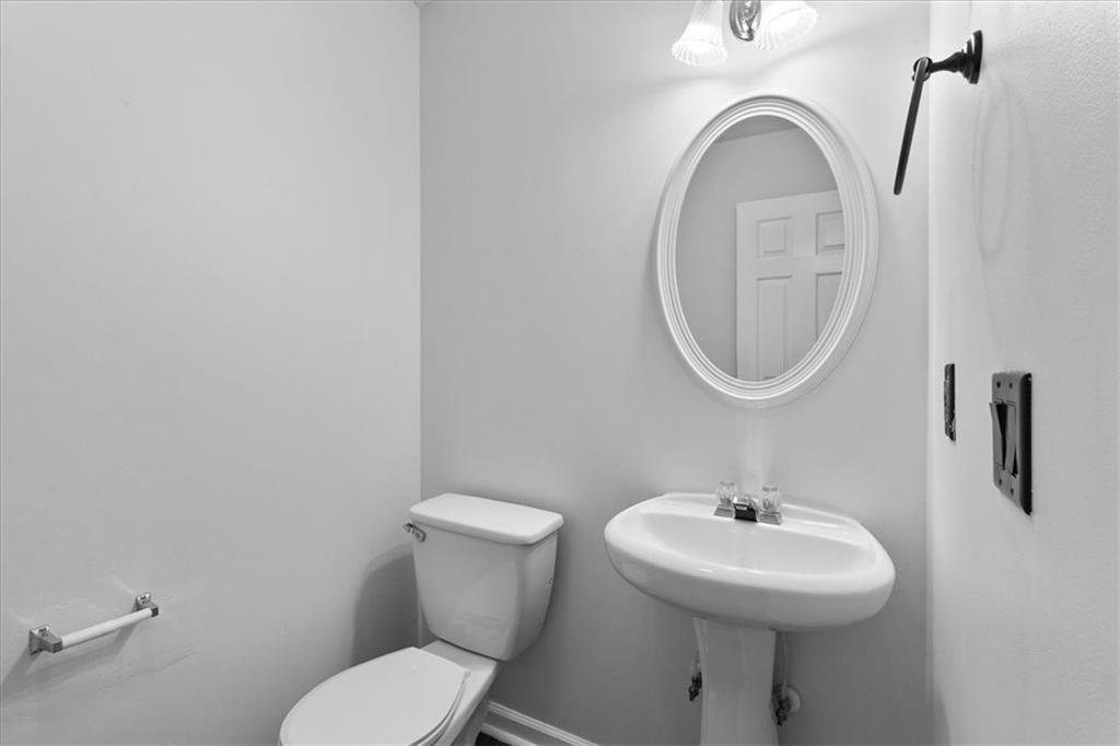 307 Meadows Lane Canton, GA 30114 - Photo 15 of 33 a bathroom with a sink mirror and toilet