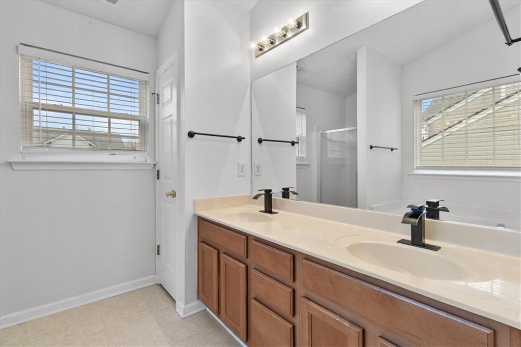 307 Meadows Lane Canton, GA 30114 - Photo 20 of 33 a bathroom with a sink and a mirror