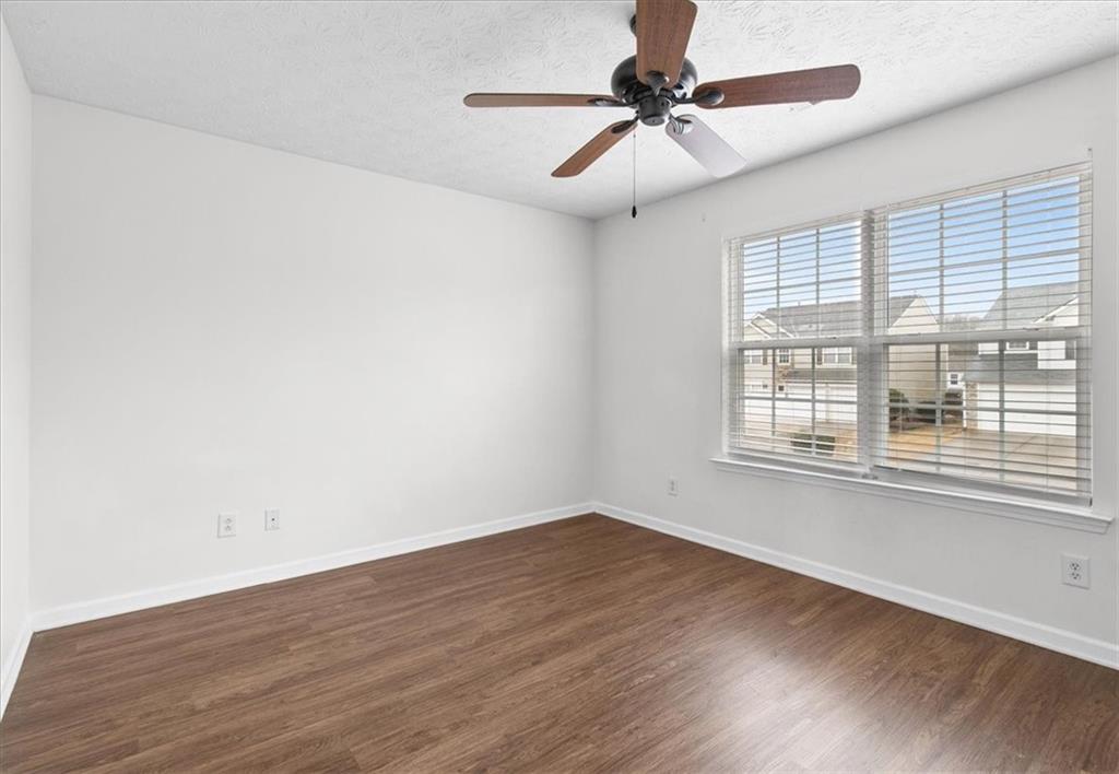 307 Meadows Lane Canton, GA 30114 - Photo 23 of 33 wooden floor in an empty room with a window