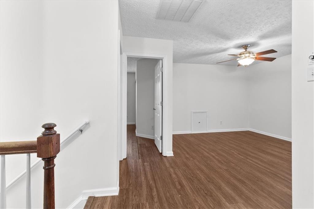 307 Meadows Lane Canton, GA 30114 - Photo 26 of 33 a view of a room with wooden floor and a ceiling fan