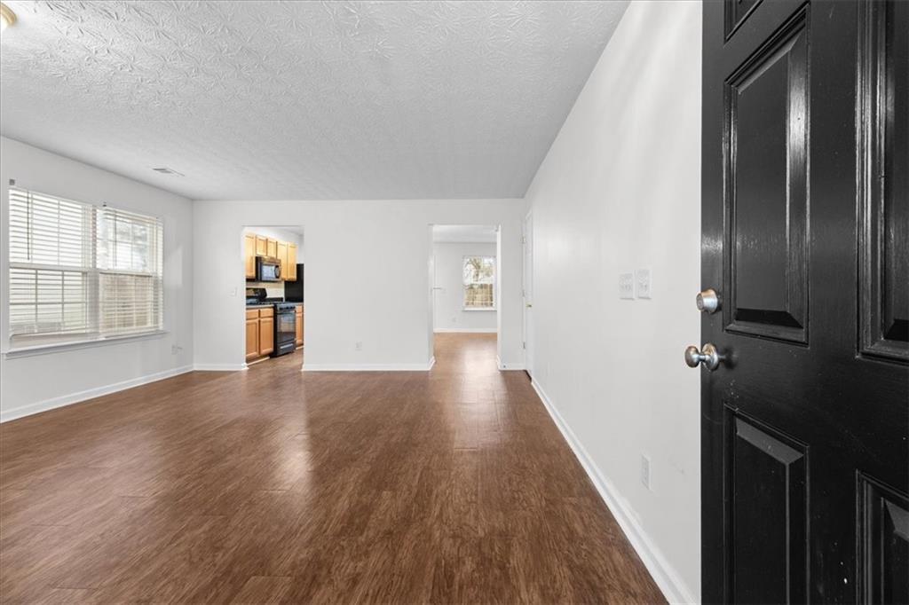 307 Meadows Lane Canton, GA 30114 - Photo 4 of 33 wooden floor in a hall with an entryway
