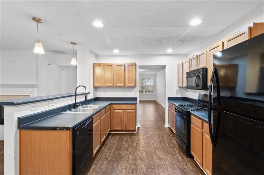 307 Meadows Lane Canton, GA 30114 - Photo 7 of 33 a kitchen with stainless steel appliances granite countertop a sink a stove and a refrigerator
