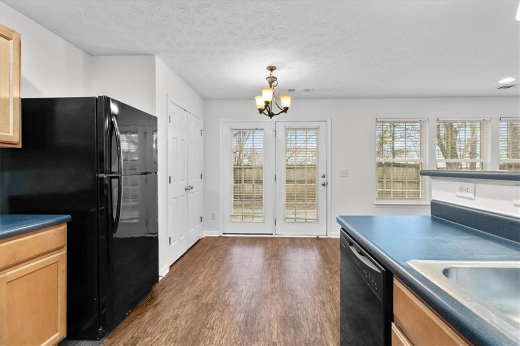 307 Meadows Lane Canton, GA 30114 - Photo 9 of 33 a kitchen with stainless steel appliances a refrigerator sink and stove