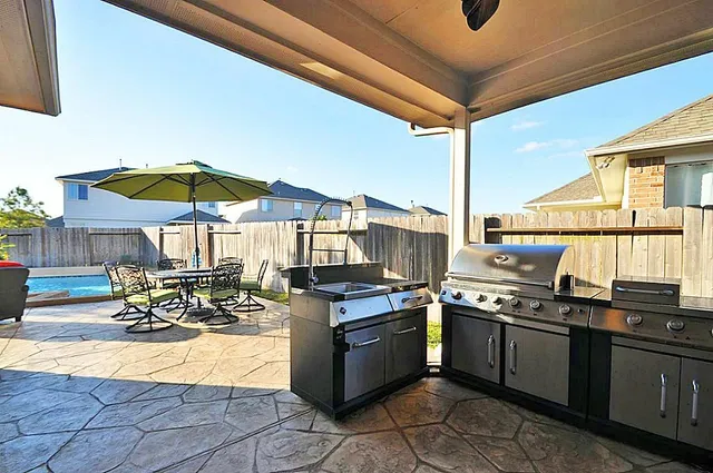 a kitchen with stainless steel appliances kitchen island granite countertop a stove a sink and a microwave