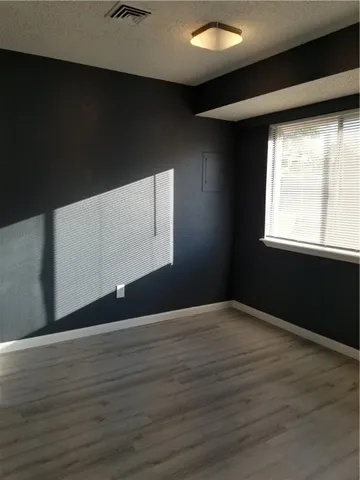 a kitchen with a refrigerator a sink and white cabinets