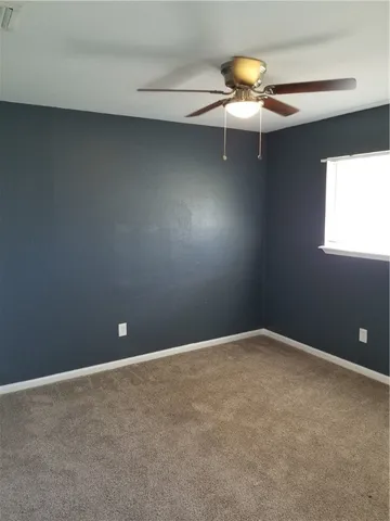 a bathroom with a sink toilet and window