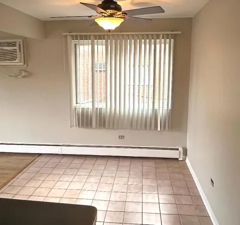 a view of a livingroom with wooden floor and white walls