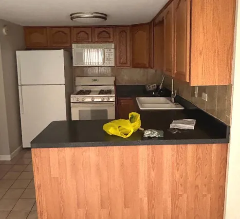 a kitchen with a sink a stove and a refrigerator