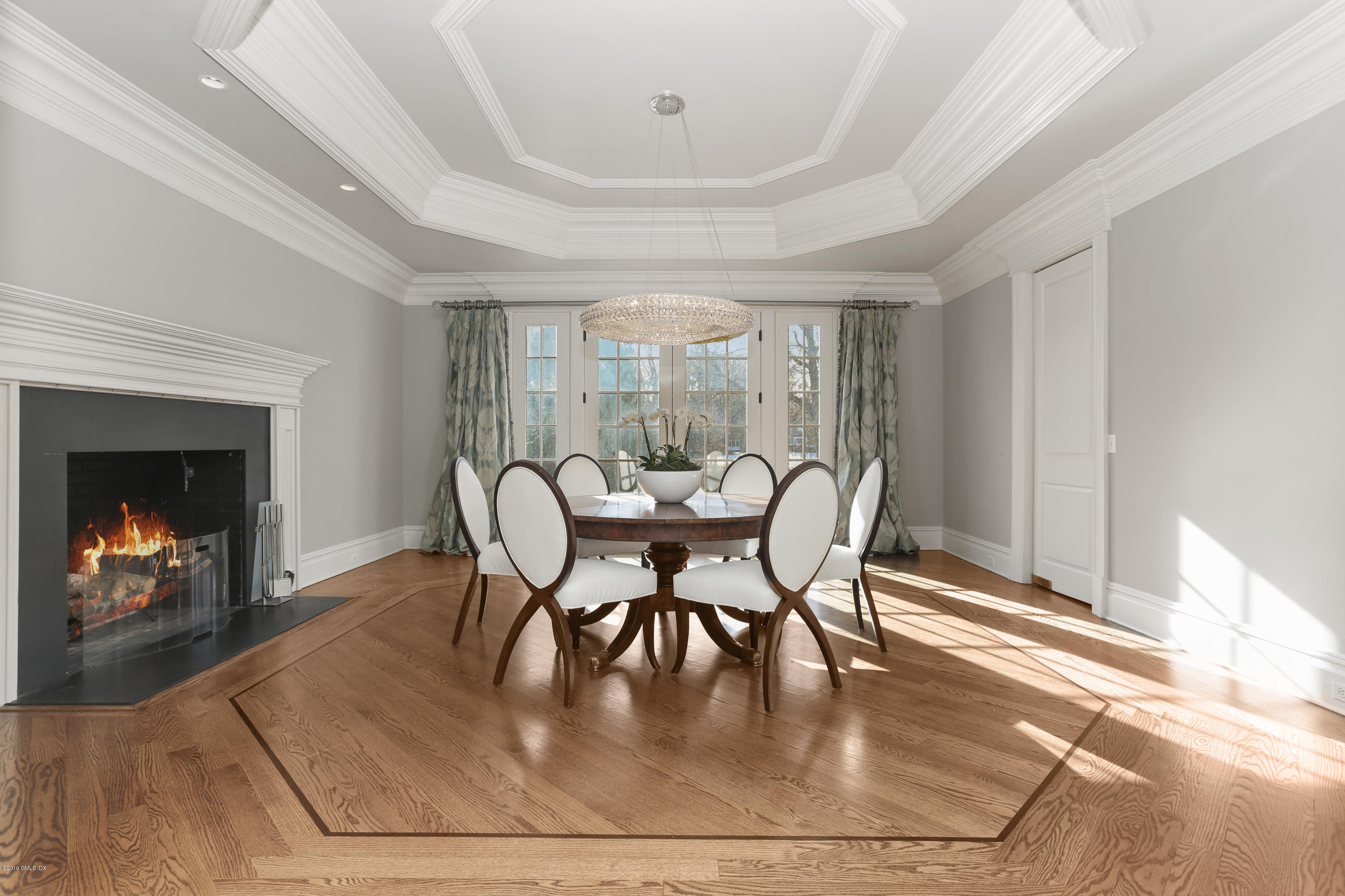 10 Andrews Road Greenwich, CT 06830 - Photo 11 of 29 a dining room with furniture a fireplace and wooden floor