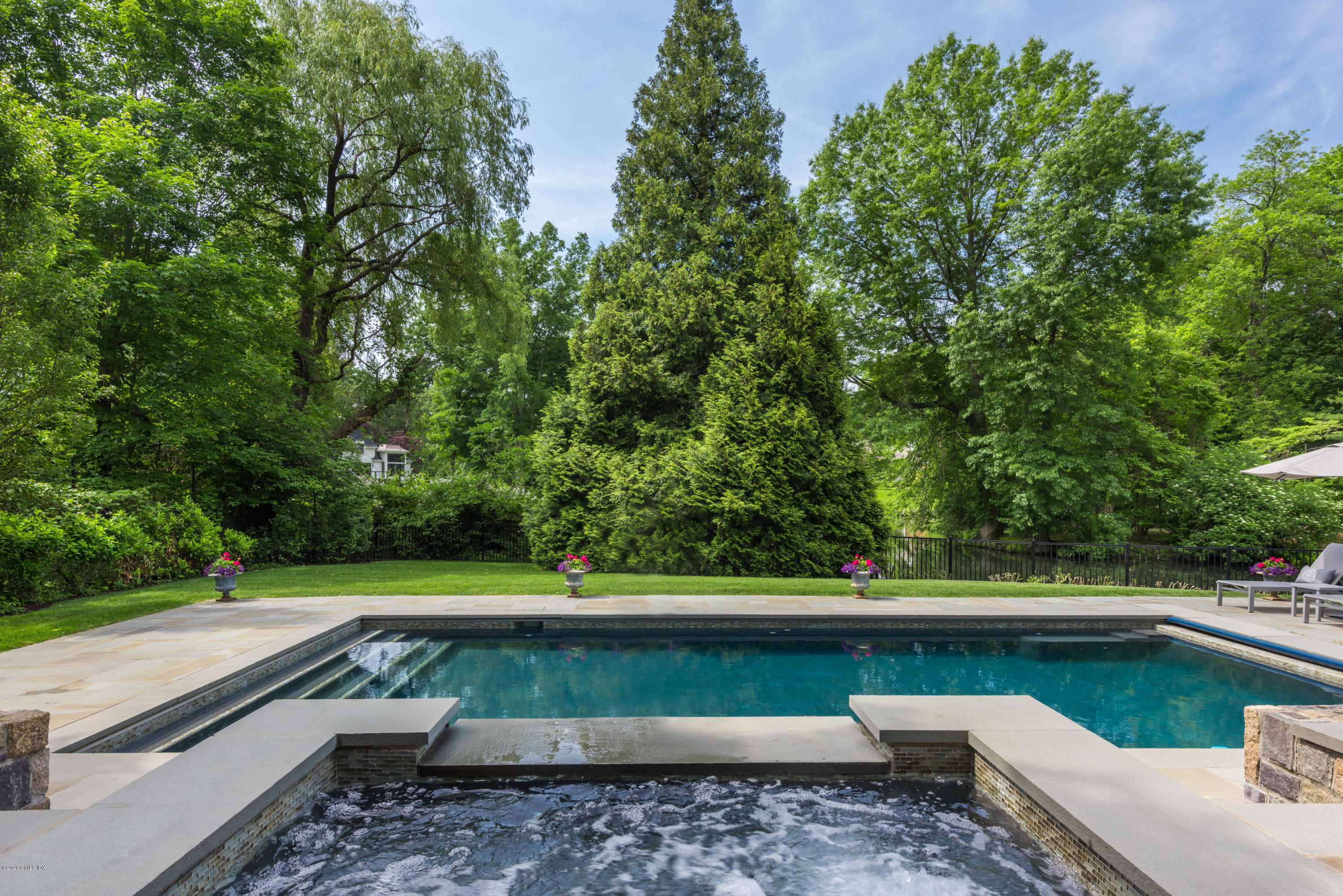 10 Andrews Road Greenwich, CT 06830 - Photo 23 of 29 a view of swimming pool with seating area and trees around
