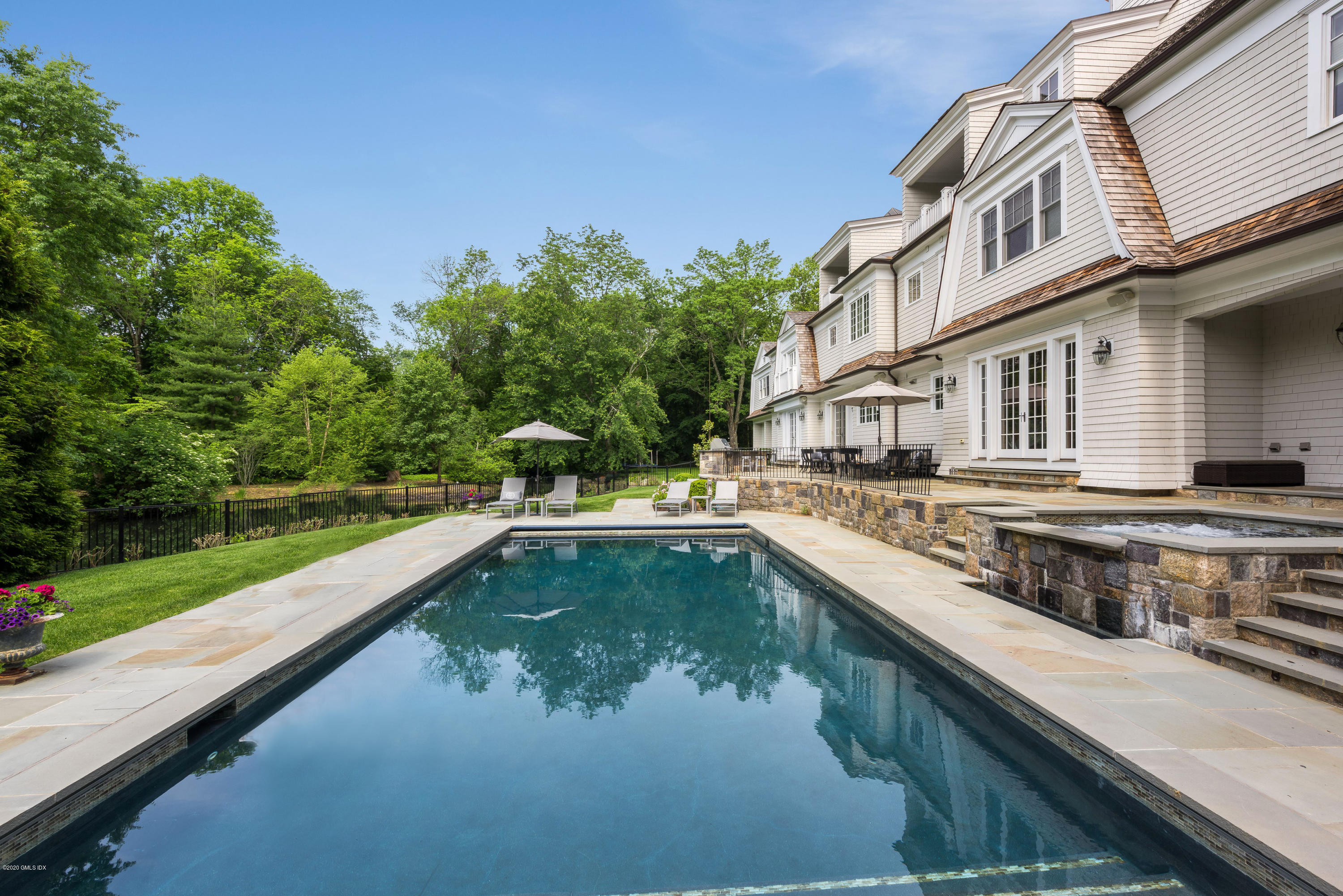10 Andrews Road Greenwich, CT 06830 - Photo 24 of 29 a view of a house with a swimming pool