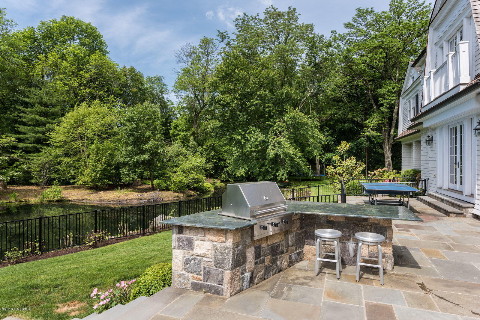 10 Andrews Road Greenwich, CT 06830 - Photo 25 of 29 a view of house with backyard and outdoor seating