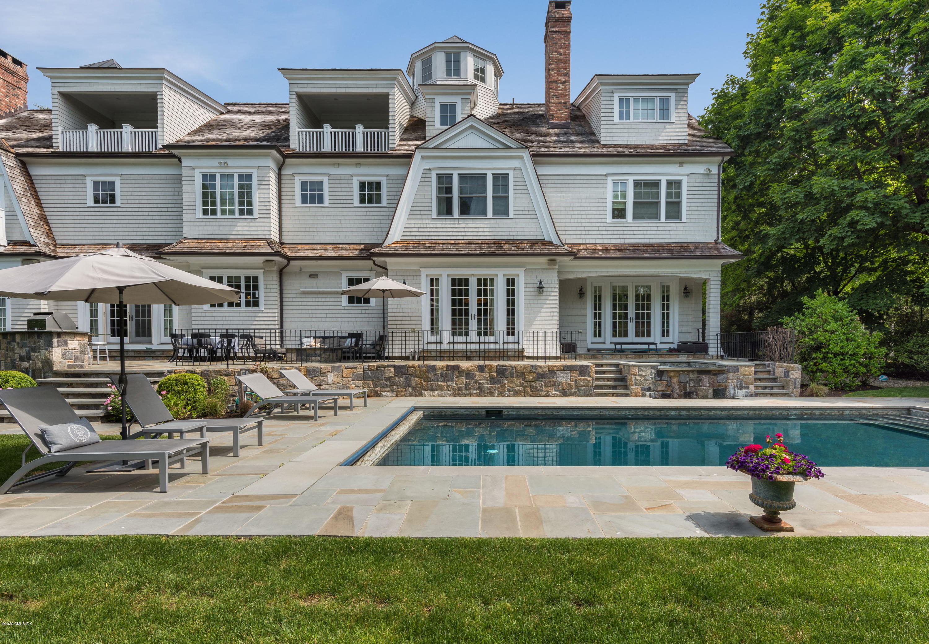 10 Andrews Road Greenwich, CT 06830 - Photo 4 of 29 a front view of house with yard and outdoor seating