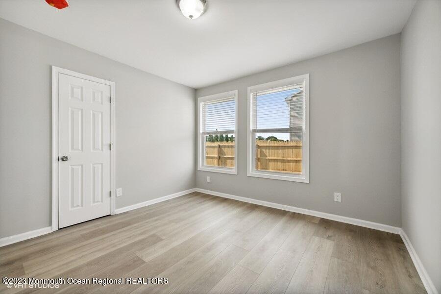 3 Monroe Street Keyport, NJ 07735 - Photo 12 of 16 a view of an empty room with wooden floor and a window