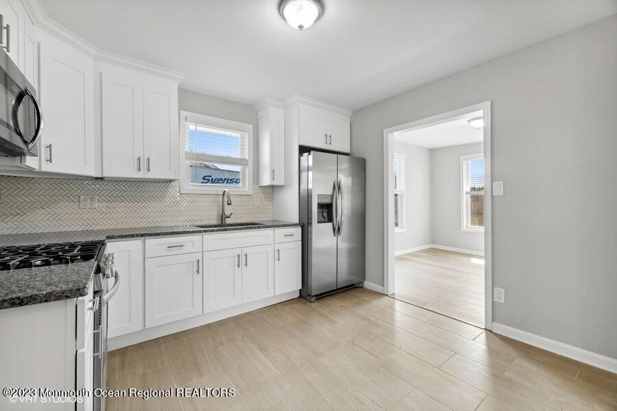 3 Monroe Street Keyport, NJ 07735 - Photo 8 of 16 a kitchen with stainless steel appliances granite countertop a refrigerator and a stove