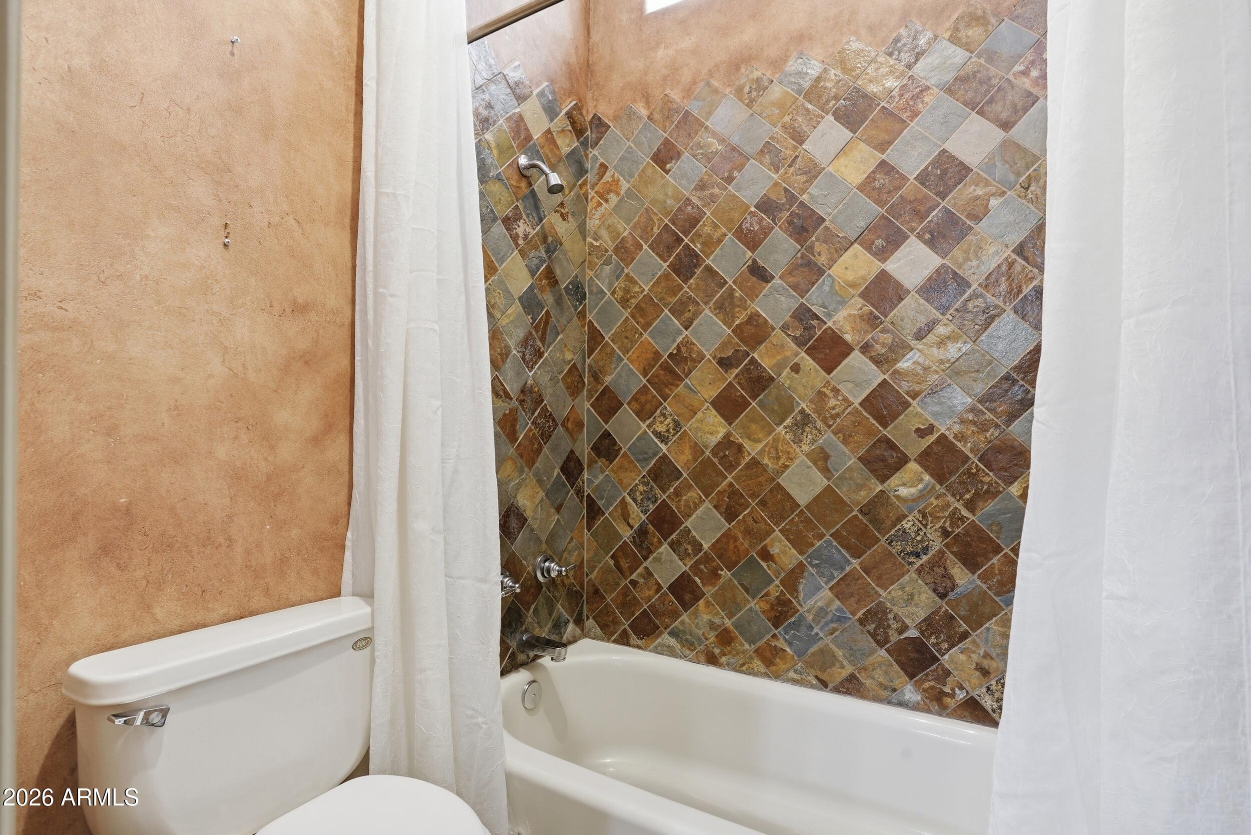 6334 East Albany Street Mesa, AZ 85205 - Photo 35 of 72 a bathroom with a toilet and a bathtub