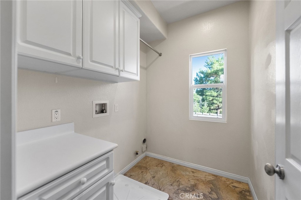 28889 Edenton Way Temecula, CA 92591 - Photo 27 of 56 Laundry room with lots of cabinets and window that opens for fresh air.