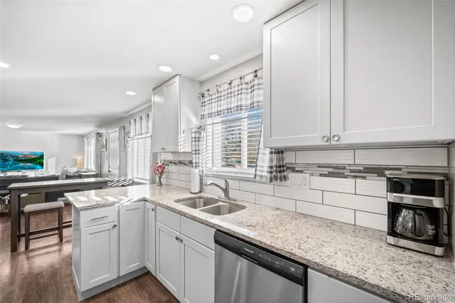 a kitchen with stainless steel appliances granite countertop a sink stove and cabinets