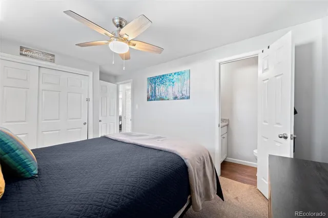 a bedroom with a large bed and a ceiling fan