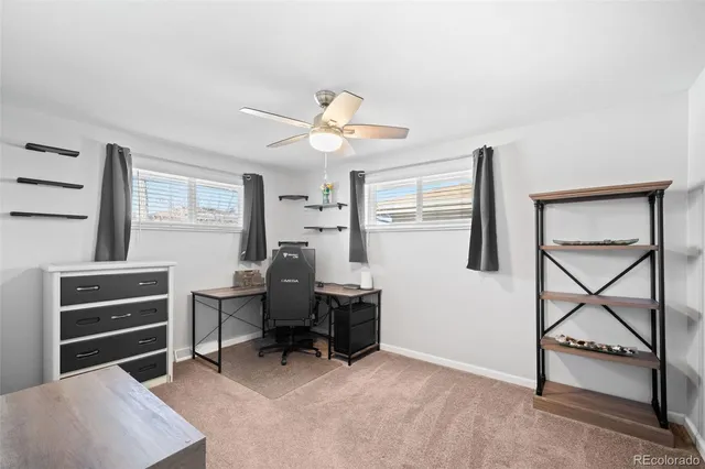 a view of a workspace with furniture and a window