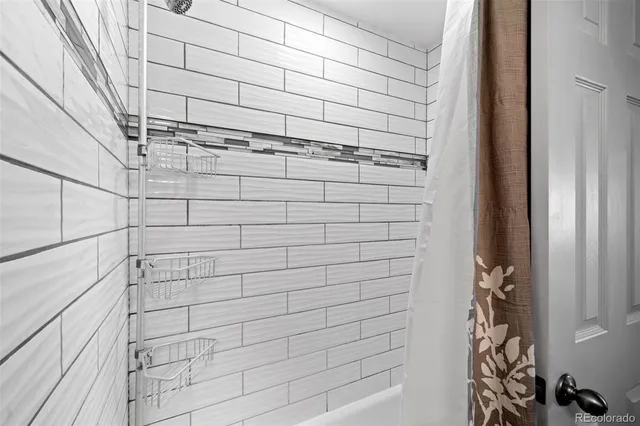 a bathroom with a granite countertop sink and a toilet