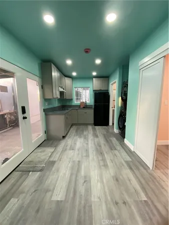 a view of a kitchen with a sink and a refrigerator