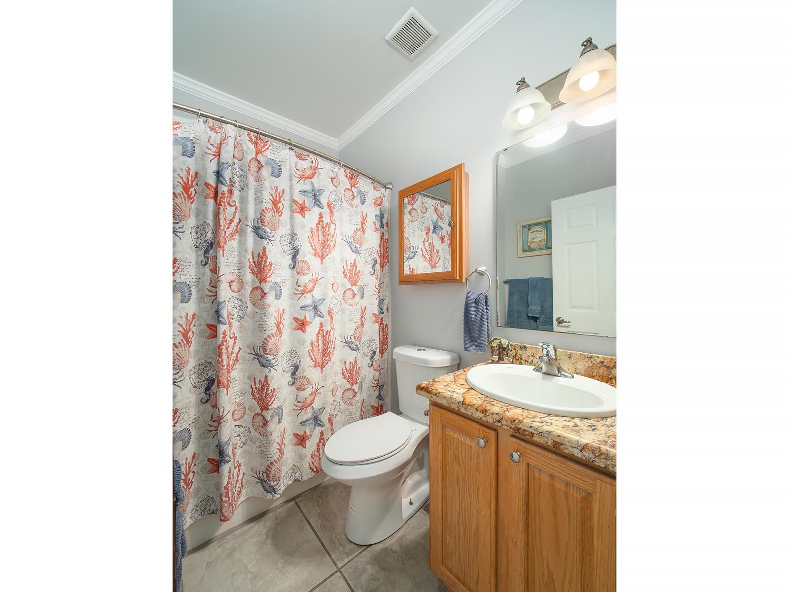 83 Palm Drive Key West, FL 33040 - Photo 15 of 35 a bathroom with a granite countertop sink mirror vanity and toilet