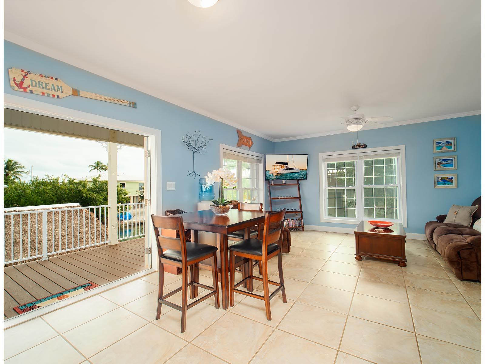 83 Palm Drive Key West, FL 33040 - Photo 3 of 35 a view of a dining room with furniture window and outside view