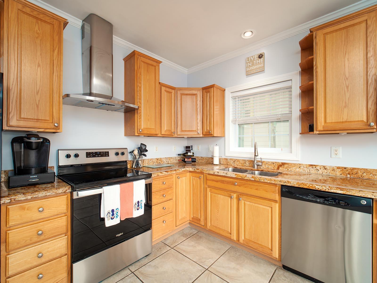 83 Palm Drive Key West, FL 33040 - Photo 6 of 35 a kitchen with stainless steel appliances granite countertop a sink stove and cabinets
