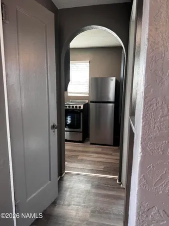a view of empty room with wooden floor