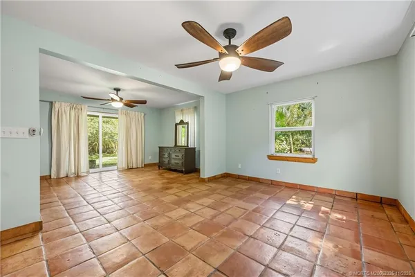 a view of a livingroom with a ceiling fan and window