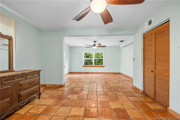 a view of room with window and ceiling fan