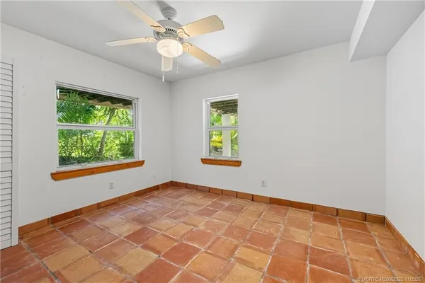 a room with walk in closet and empty racks