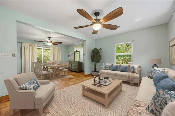 a living room with furniture a large window and a table