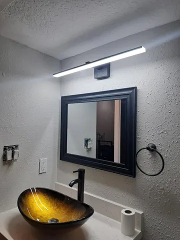 a bathroom with a mirror and a shower