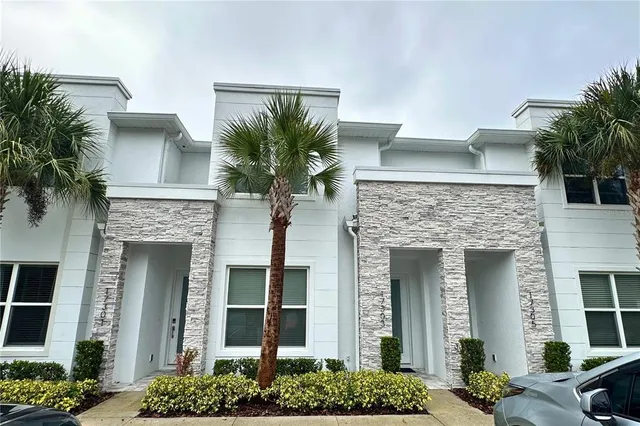 a front view of a house with plants