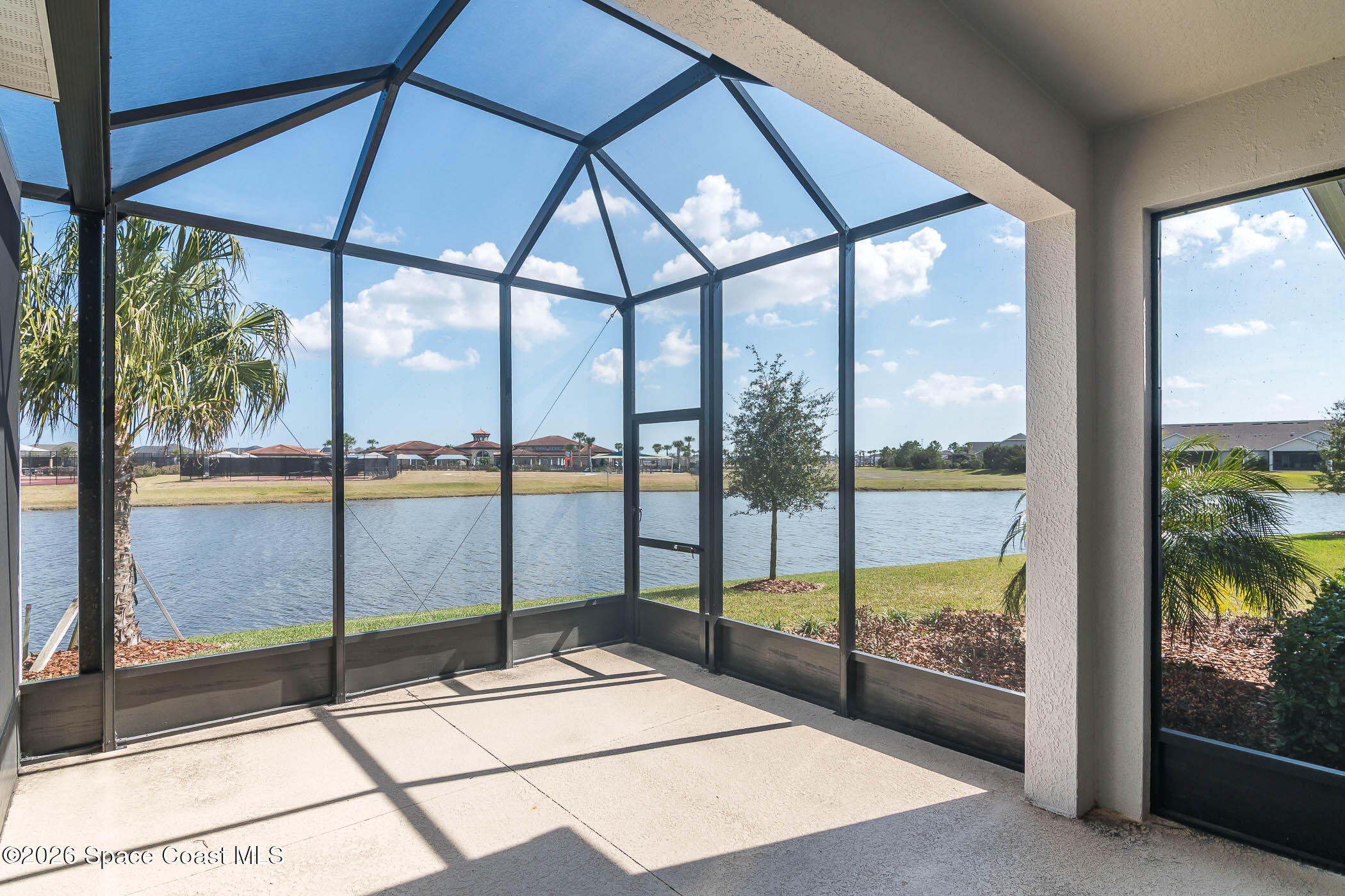 7929 Cache Crk Lane Melbourne, FL 32940 - Photo 12 of 45 a building view with a glass door and glass door