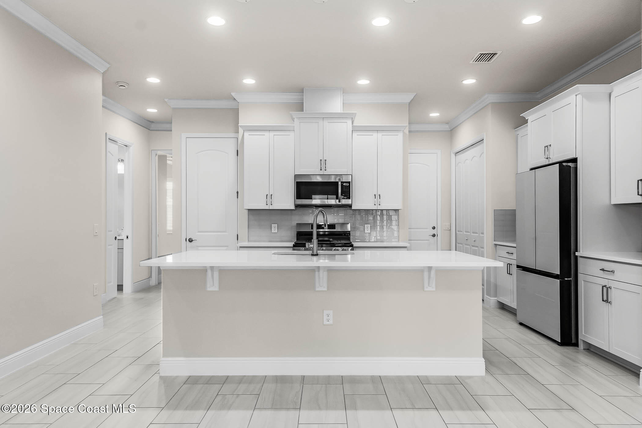 7929 Cache Crk Lane Melbourne, FL 32940 - Photo 15 of 45 a view of kitchen with stainless steel appliances granite countertop a stove top oven a sink and a refrigerator