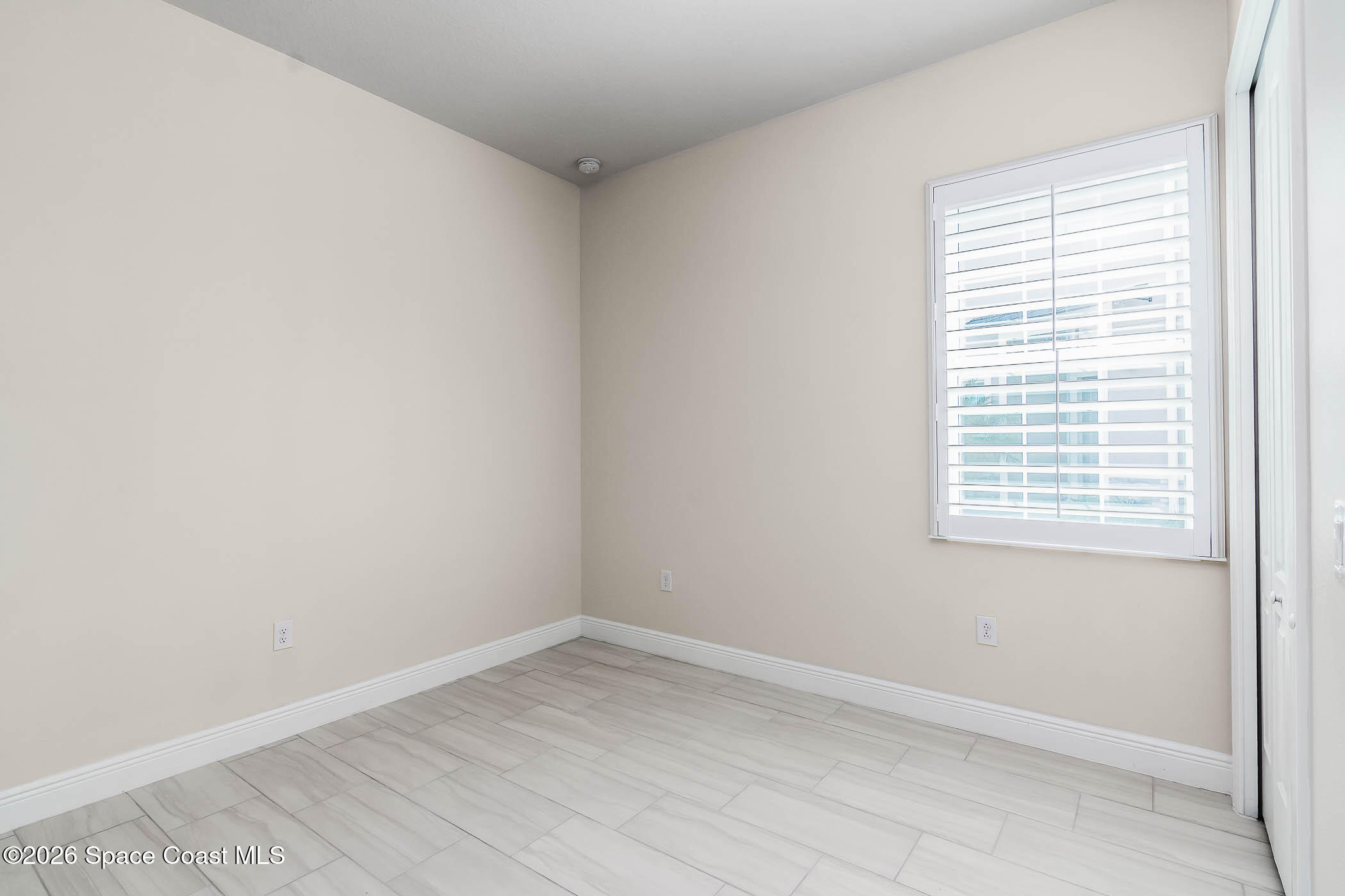 7929 Cache Crk Lane Melbourne, FL 32940 - Photo 21 of 45 an empty room with a window