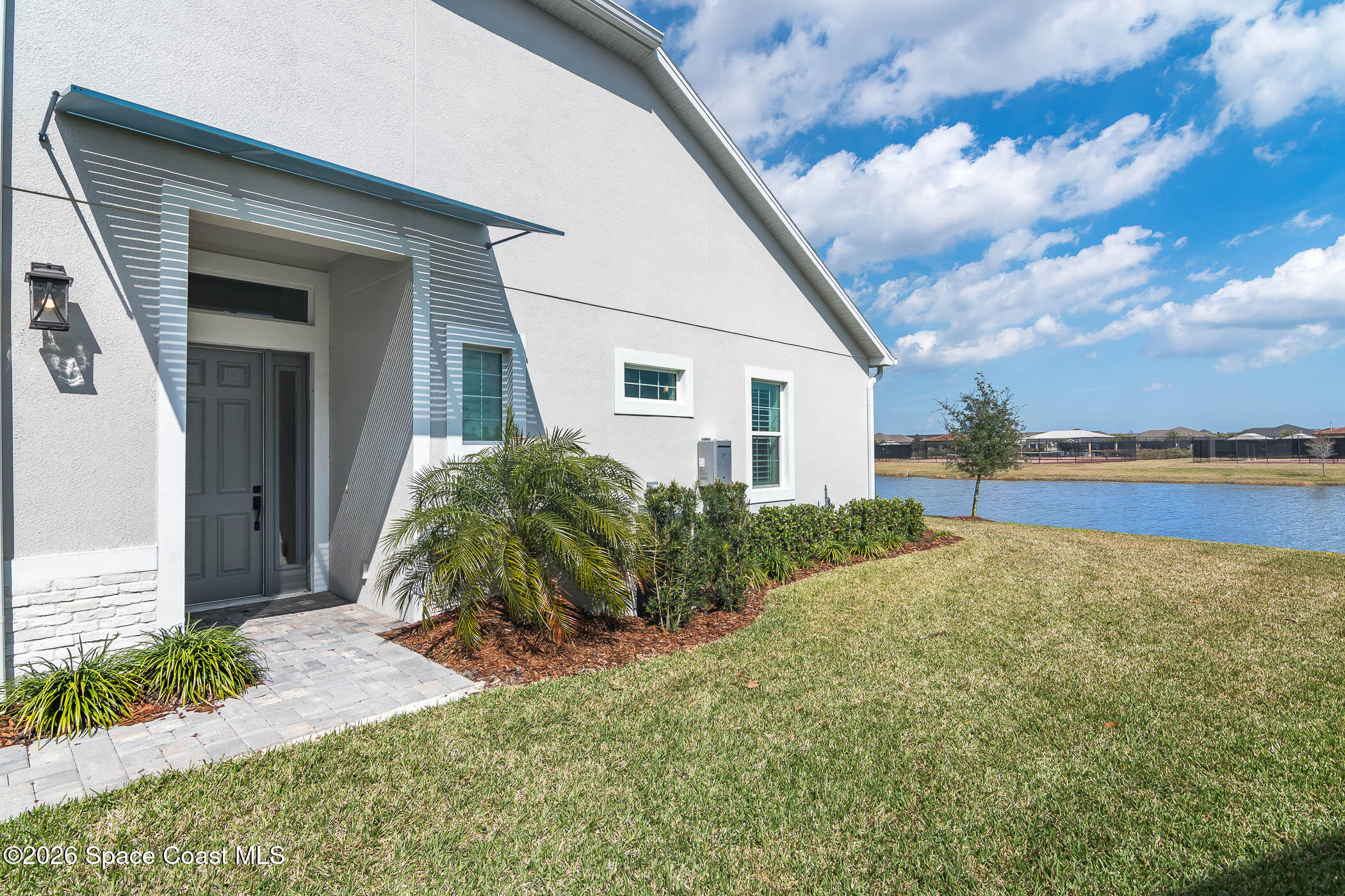 7929 Cache Crk Lane Melbourne, FL 32940 - Photo 26 of 45 a house with garden in front of it