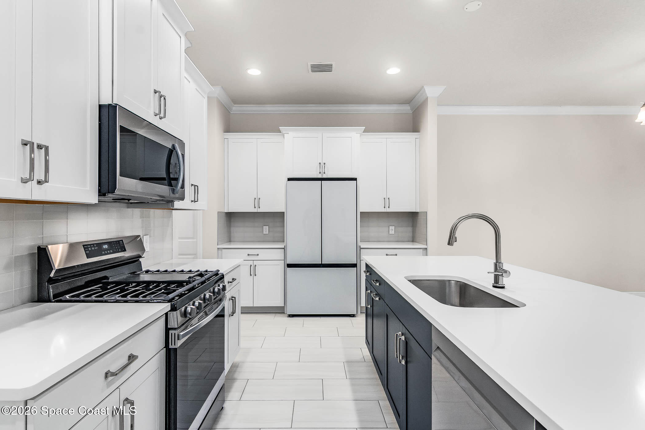 7929 Cache Crk Lane Melbourne, FL 32940 - Photo 4 of 45 a kitchen with stainless steel appliances granite countertop a sink stove a refrigerator and cabinets