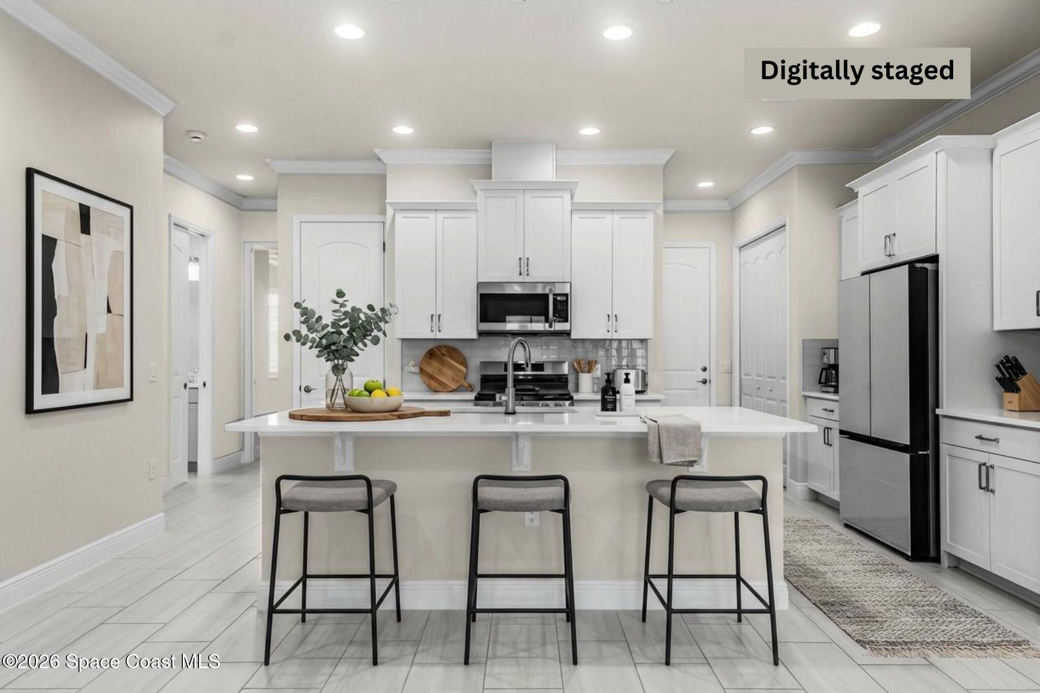 7929 Cache Crk Lane Melbourne, FL 32940 - Photo 41 of 45 a kitchen with kitchen island cabinets and refrigerator