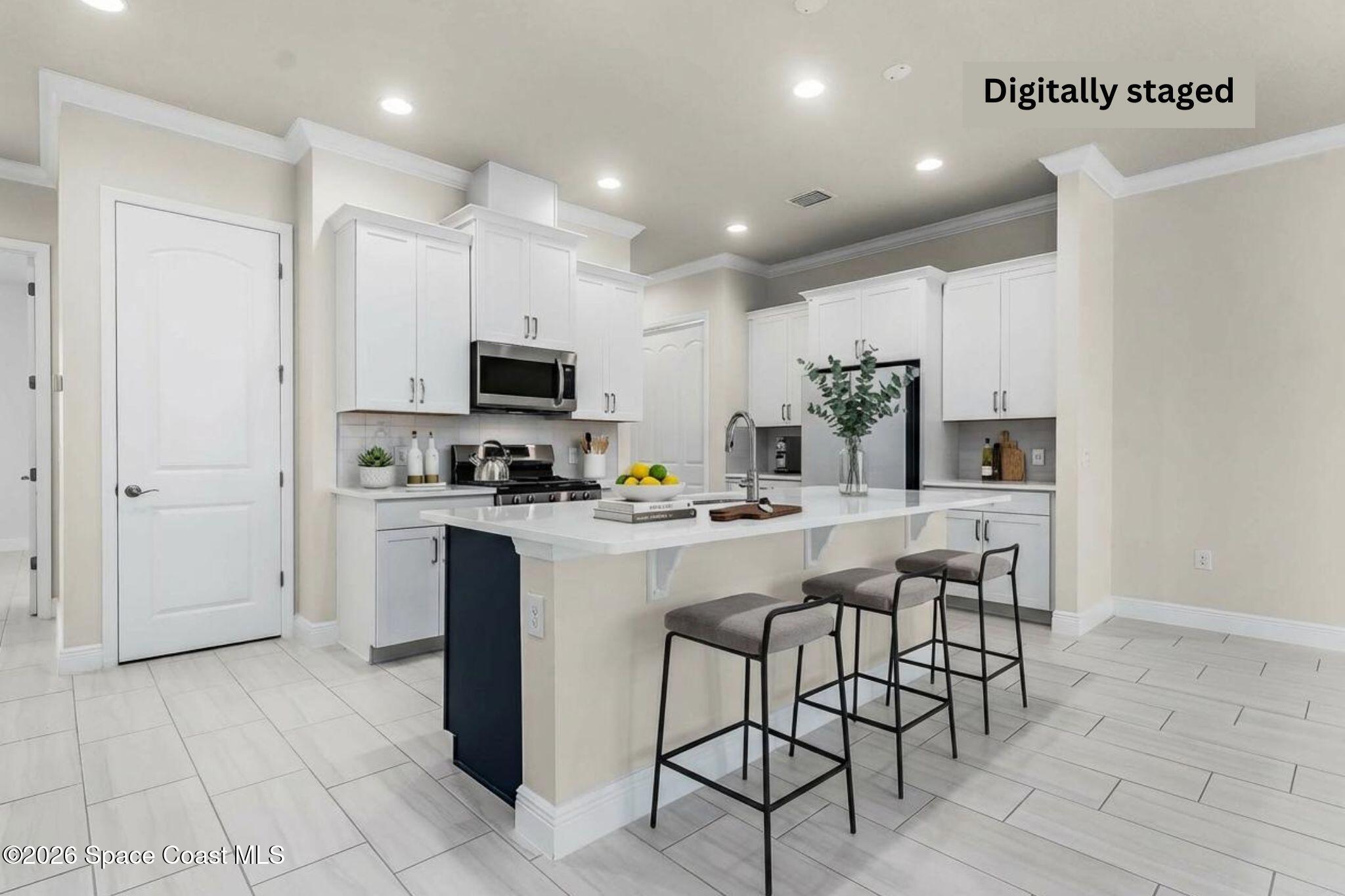 7929 Cache Crk Lane Melbourne, FL 32940 - Photo 42 of 45 a kitchen with a sink a microwave and refrigerator