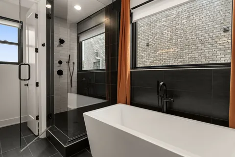 a bathroom with a bathtub and a shower