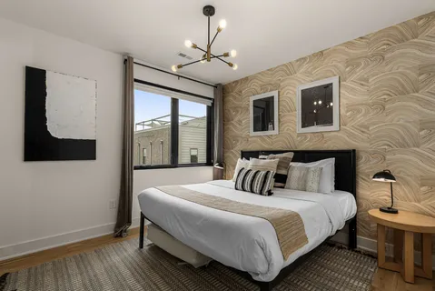 a bedroom with a large bed and a window