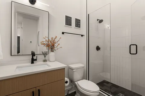 a bathroom with a sink toilet and shower