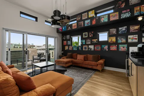 a living room with furniture a window and a flat screen tv